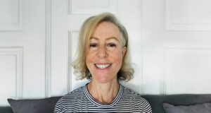 DNRS patient, Amy, sitting in a chair in her living room.