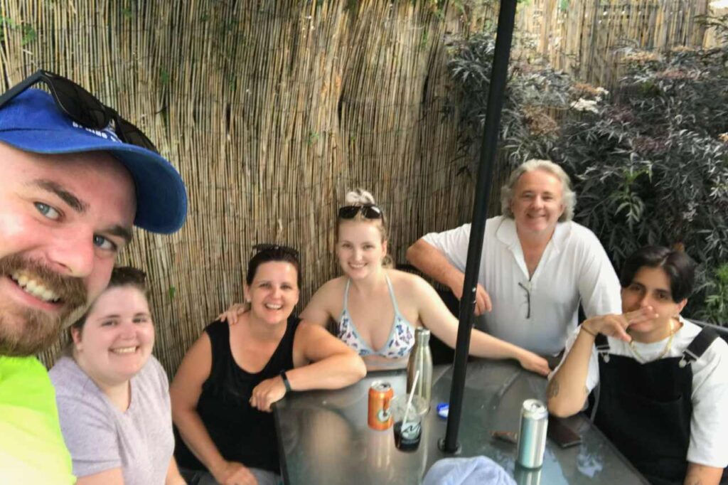 Madison hanging out with her friends and family, taking a selfie at restaurant table.